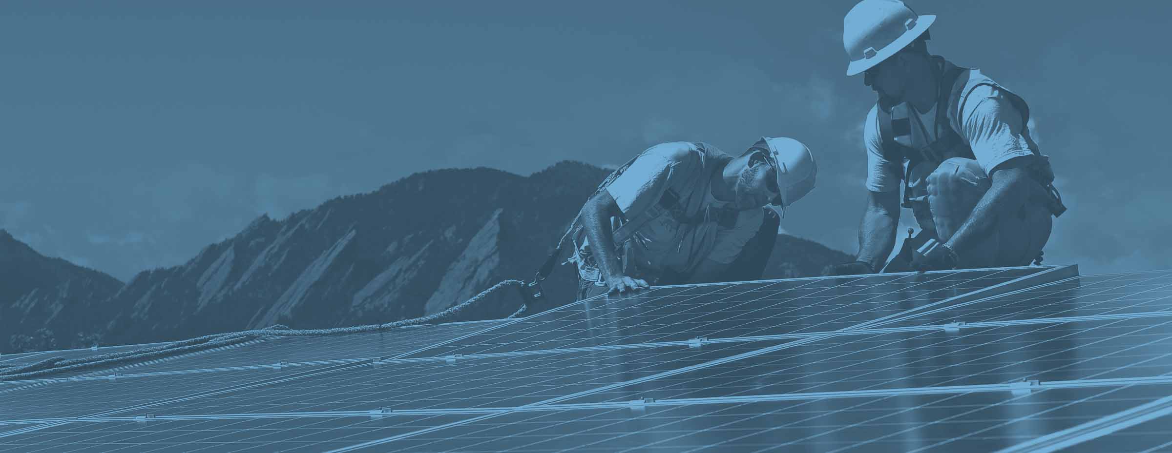 Solar installers with Flatirons in background